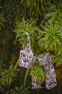 bra and leggings hanging from a tropical tree