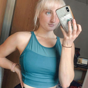 A selfie of a woman wearing a seaav mesh top bra